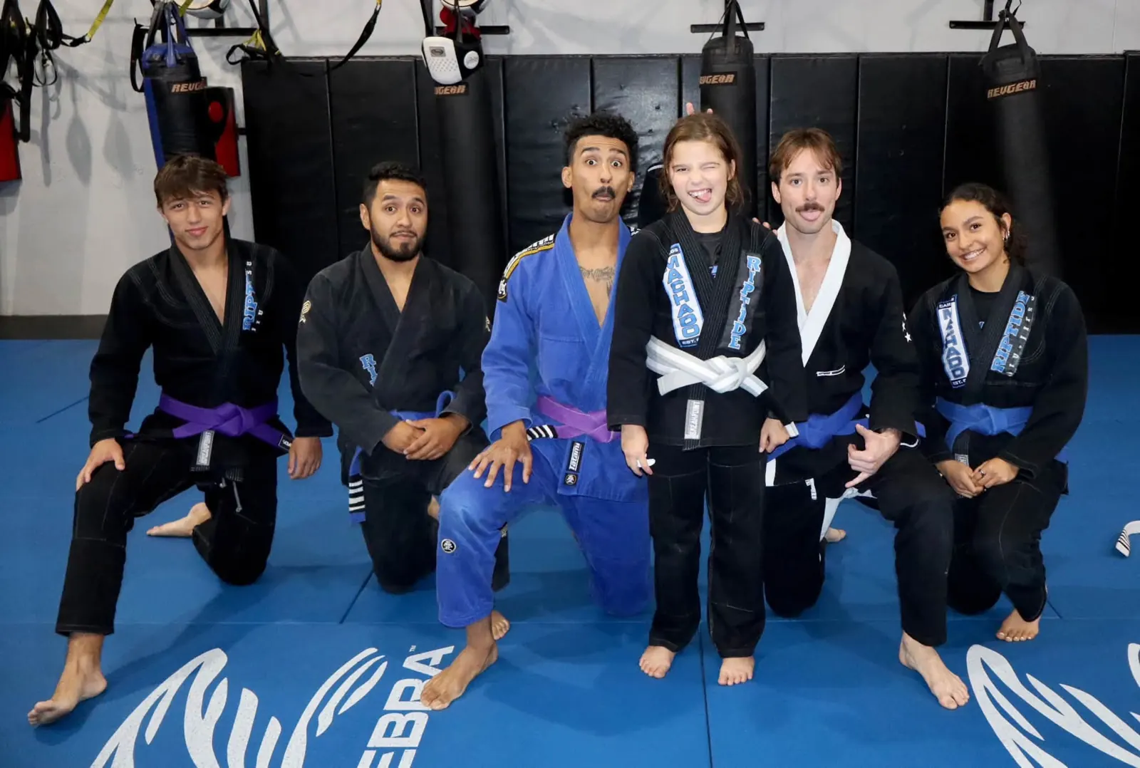 Jiu-Jitsu students together on the blue mats at Riptide